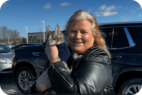 Happy family with their Cavalier puppy