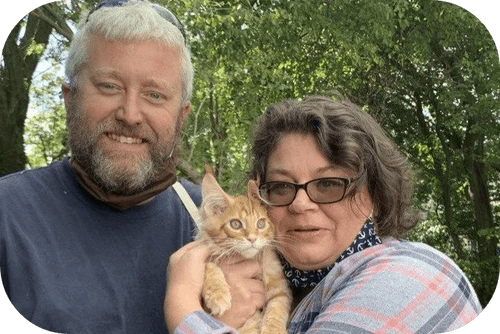 Happy family with their Cavalier puppy