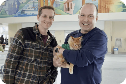 Happy family with their Cavalier puppy