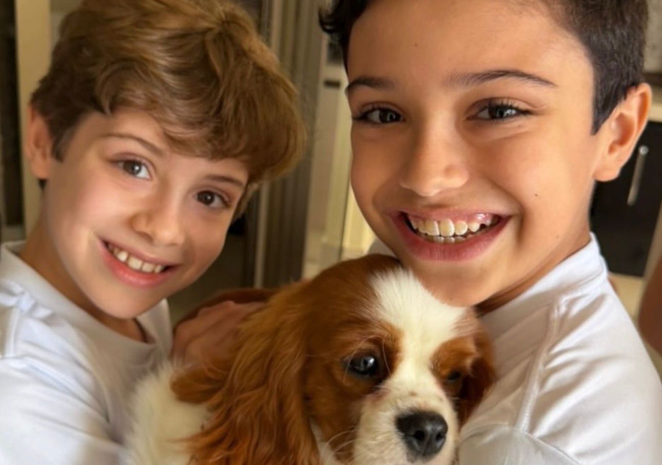 Happy family with their Cavalier puppy