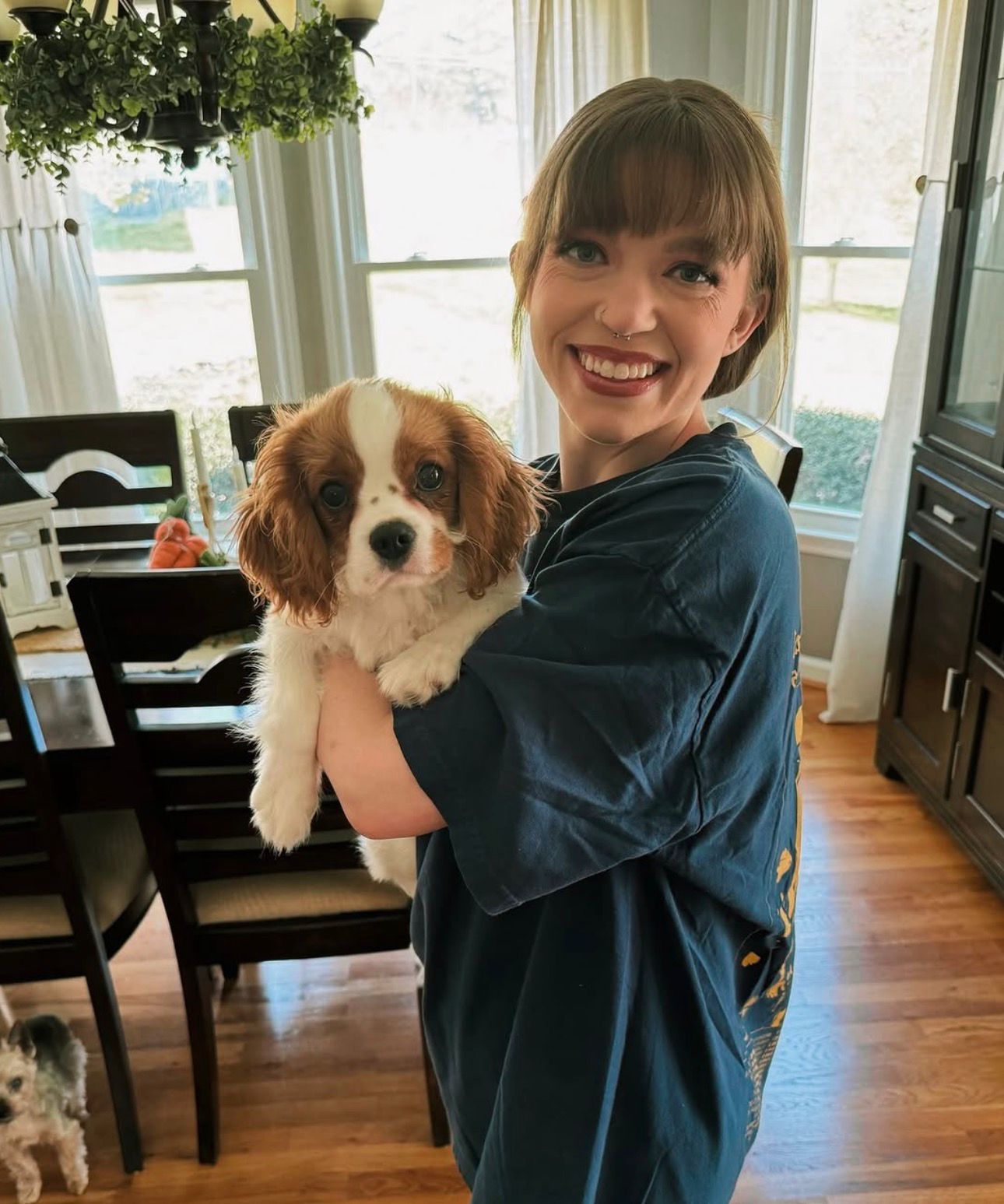 Happy family with their Cavalier puppy