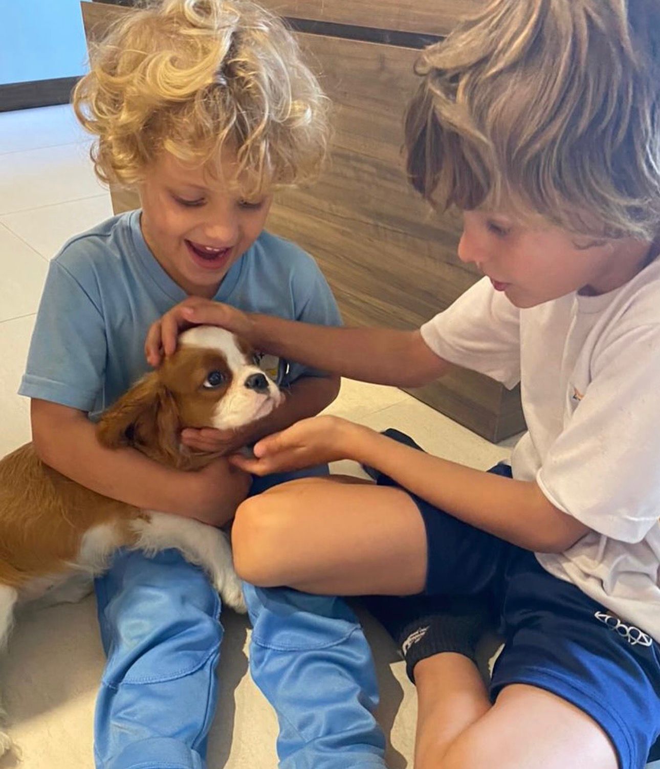 Happy family with their Cavalier puppy